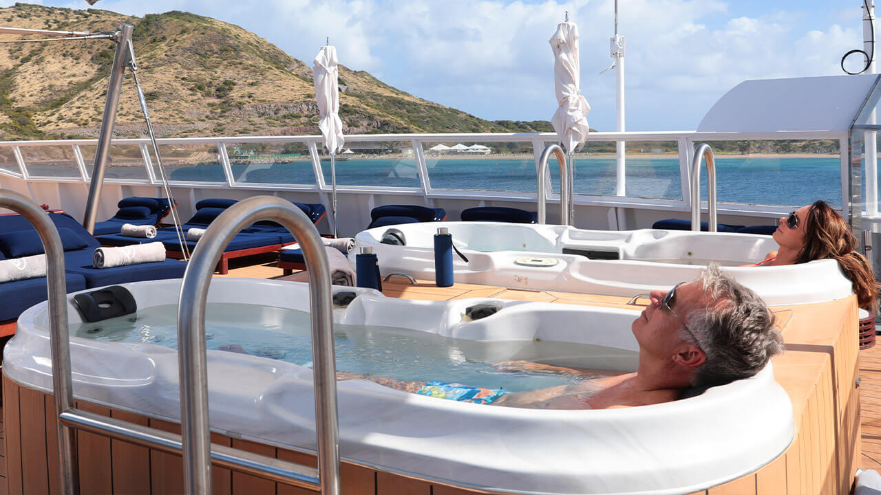 Couple relaxing in jacuzzis onboard SeaDream